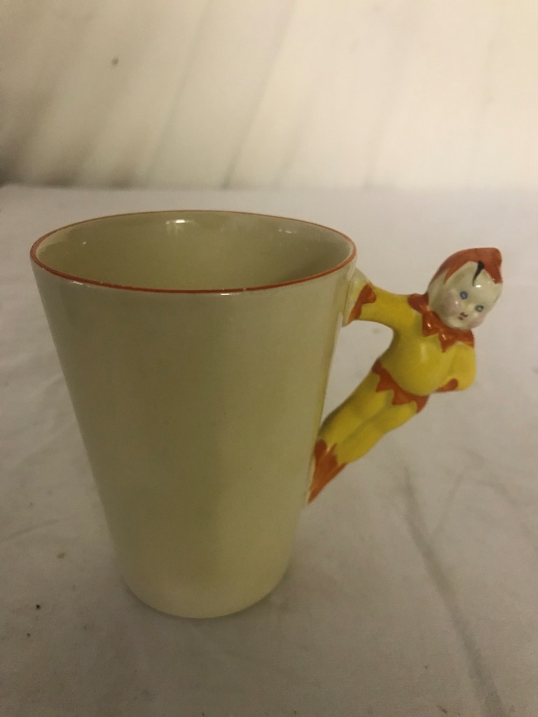 A Clarice Cliff chocolate mug with pixie handle