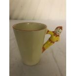 A Clarice Cliff chocolate mug with pixie handle