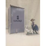 A boxed Lladro figure of a child with a gaggle of geese