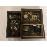 A box of silver jewellery, military badges,