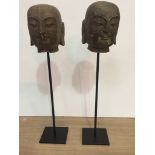 A pair of stone Buddha heads,