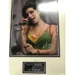 A framed and glazed signed photograph of Amy Winehouse (with COA)