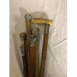 Three silver topped malacca walking canes,