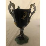 A Continental three-handled goblet with hand-painted fruit to central cartouche