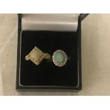 Two gold rings set opals