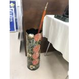 A painted umbrella stand with walking stick