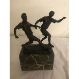 Bronze footballers on a marble base