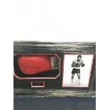 A signed Ken Norton boxing glove: framed and glazed with CoA