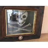 A skull and crossbones decoration in a wooden frame