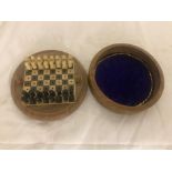 A miniature cased circular chess set