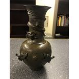 A Chinese bronze vase with dragon decoration