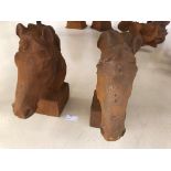 A small pair of cast-iron horses heads