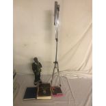 A metal figure of a saxophonist; together with a music stand,