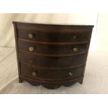 A 19th century bow-fronted miniature chest of drawers
