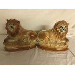 A pair of Staffordshire lions