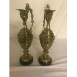 A pair of brass ewers