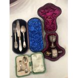 A hallmarked silver cased christening and feeding set;