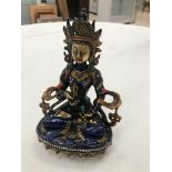 A cast metal enamelled East Asian deity