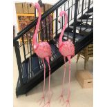 A pair of metal pink flamingoes