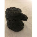 A bronze inkwell in the form of an eagle's head