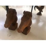 A pair of cast metal horses heads