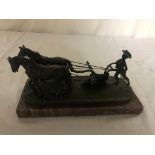 A cast bronze of a ploughman