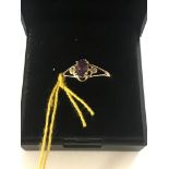 A 9ct gold oval natural amethyst and diamond ring