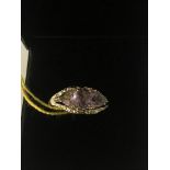 A 9ct gold three-stone amethyst and diamond ring