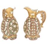 A Pair of Zsolnay Pecs Reticulated Ewers: Gilded ground with green leaf and white flowers,