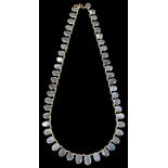 An 18K Moonstone Necklace: Large oval cut Moonstones set on an 18k chain