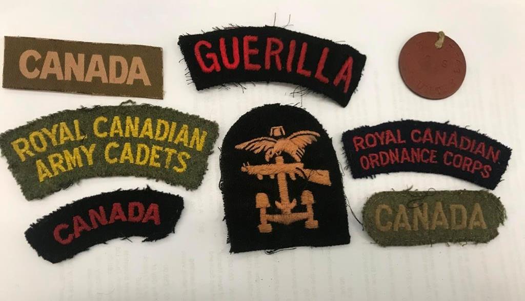 A collection of D-Day Combined Operations Canadian Unit patches and shoulder titles with dog tags