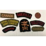 A collection of D-Day Combined Operations Canadian Unit patches and shoulder titles with dog tags