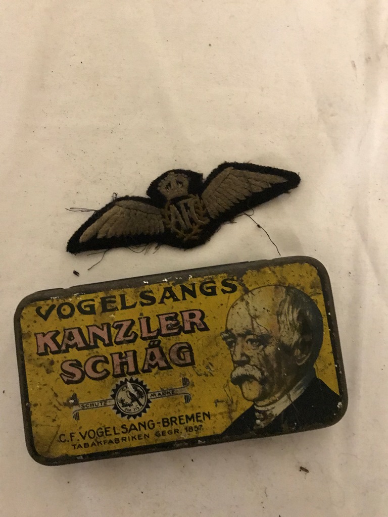 An Australian Flying Corps pilot officer's wings in German tobacco tin (A/F)