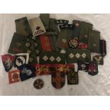 A collection of WWII and post-war cloth badges and lapels
