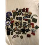 A large collection of original WWI & WWII officer pip cloth patches and badges,