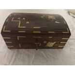A wooden jewellery box with ornate brass bound decoration