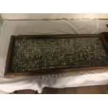 A large collection of enamel bowling badges from the 1930s onwards in a large glass display case