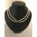 A twin-strand cultured pearl necklace on a diamond and Burmese sapphire clasp