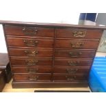 An Edwardian mahogany 12-drawer cabinet with shells,