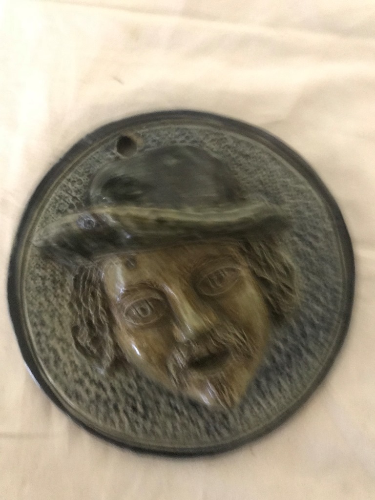 An early 19th century Fulham pottery stoneware vesta wall plaque depicting an old mans head in