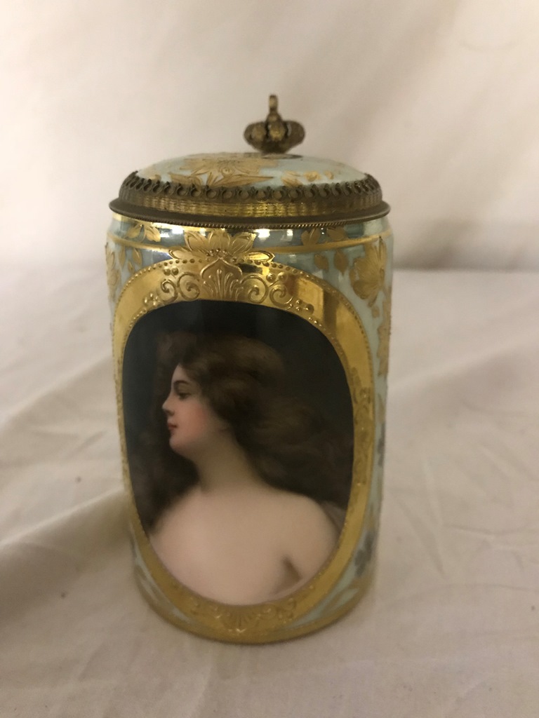 A 19th century portrait tankard with gilded floral decoration with brass mounts