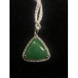 A 14K jade and diamond pendant