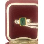 An 18ct princess cut diamonds and emerald dress ring