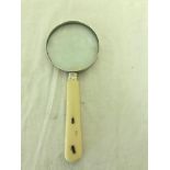 A Meiji period carved ivory and amber insect inlaid magnifying glass