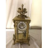 A Victorian brass mantel clock