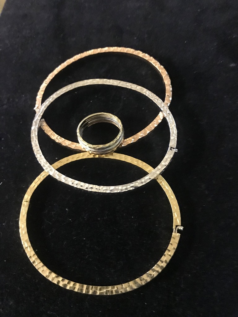 Three gold bangles;