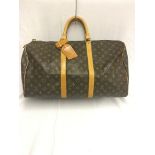 A Louis Vuitton holdall in monogram pattern;