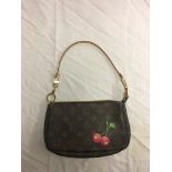 A Louis Vuitton cherry monogram clutch bag and strap;