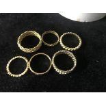 Six 9ct rings to inc braided examples