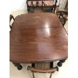 A 19th century mahogany dining table with one extra leaf